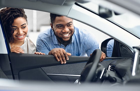 Young teen and parent buying new car