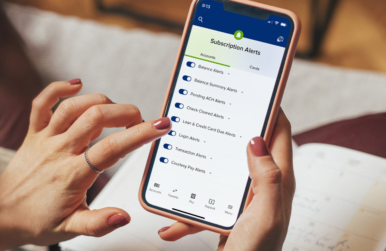 Close up of a cell phone with SELCO app with subscription alerts on the screen.