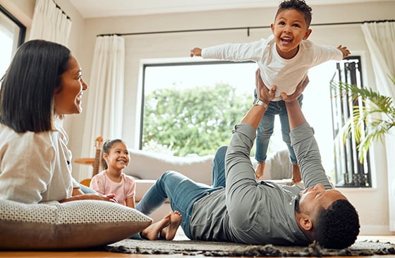 Family sitting around living room having fun. 