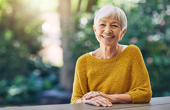 Person seated outdoors promoting free Medicare enrollment seminars for help signing up or updating 2027 Medicare coverage.