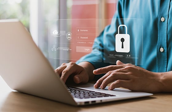 Man sitting in front of a computer making sure his SELCO community credit union account is secure. 