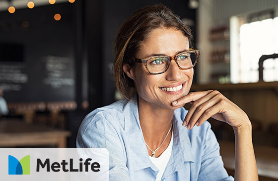 Person smiling with MetLife dental insurance logo