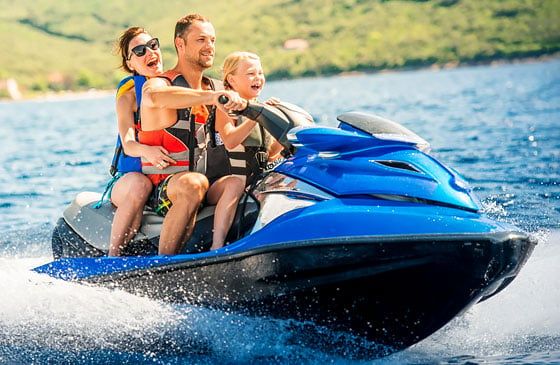 Family on a vacation with a jet ski they purchased with a SELCO loan.